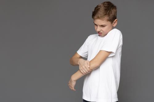 Child grabs elbow.